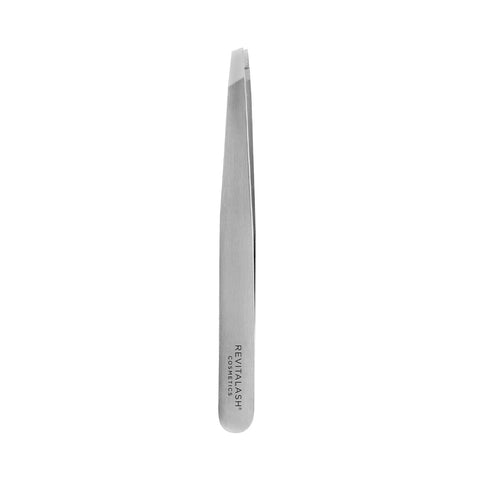 The RevitaLash Precision Tweezer is a sleek, silver metal tweezer featuring a slanted tip for perfectly groomed brows. Revitalash is engraved on the handle, highlighting its professional grade. The tweezers are displayed on a plain white background.