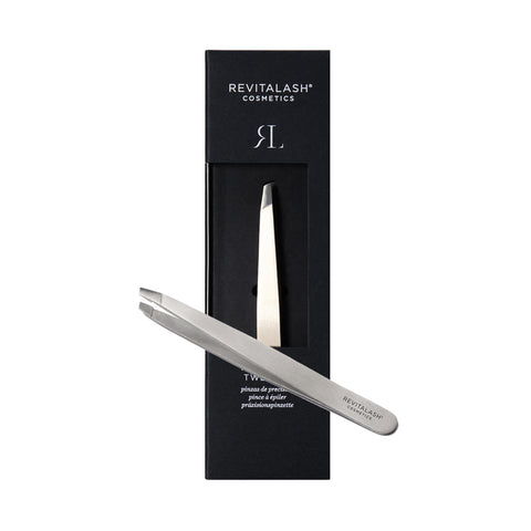 The RevitaLash Precision Tweezer, a professional-grade stainless steel tool with precise tips for perfect brows, is showcased in front of a sleek black box featuring the minimalist RevitaLash logo.