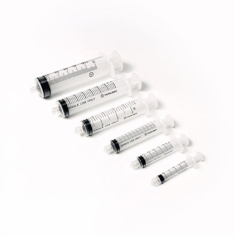 A diagonal set of six transparent MedPharma USA syringes features a 5cc Luer Lock syringe from the Excel 100/Box set. Each syringe, with black measurement markings and white plungers, is perfect for precise medication administration against a white background.