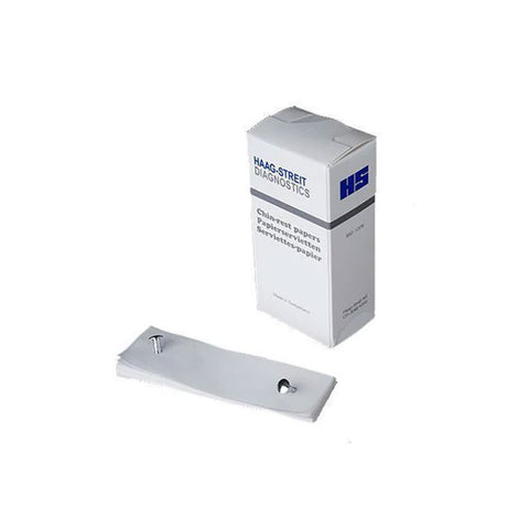 A MedPharma USA box, labeled Chin Rest Papers, Haag Streit, 500/Box, stands upright next to a stack of chart and chin rest papers, essential for hygiene. The papers are secured by a metallic clip on a light gray surface. The box features blue and black text.