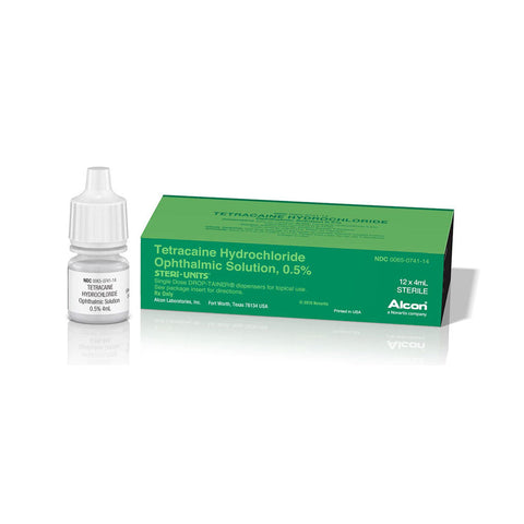 A small white dropper bottle labeled Tetracaine, 0.5%, 4mL (Alcon) from MedPharma USA sits beside a green box with product information, ready for ophthalmic procedures. The items reflect elegantly on a glossy white surface, indicating their purpose as a local anesthetic.