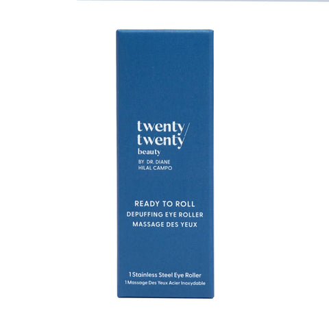A blue rectangular box with white text displays: Twenty Twenty Ready To Roll Depuffing Eye Roller by Dr. Diane Hilal-Campo. This cooling roller reduces puffiness and soothes tired eyes, featuring a stainless steel massage tool for ultimate relief.