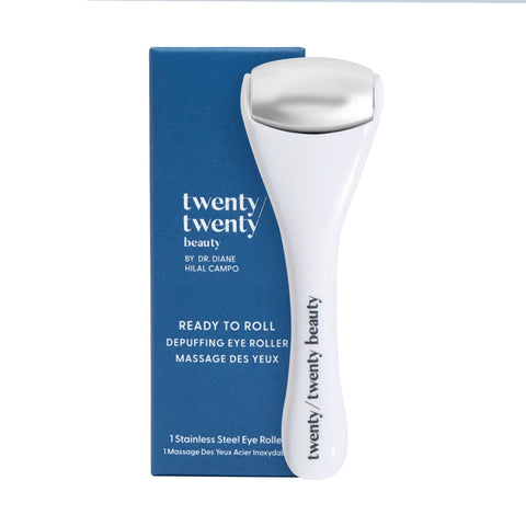 The Twenty Twenty Ready To Roll Depuffing Eye Roller, featuring a metallic head and white design, is placed in front of its blue packaging marked READY TO ROLL and By Dr. Diane Hilal Campo, designed to combat puffiness.