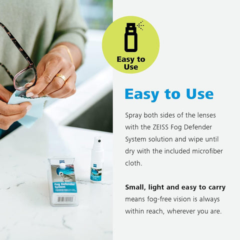 A person cleans glasses using the ZEISS Fog Defender System Anti-Fog Spray and a microfiber cloth. The packaging is on a white table. This Zeiss solution ensures easy, fog-free vision, making it light and convenient to carry.